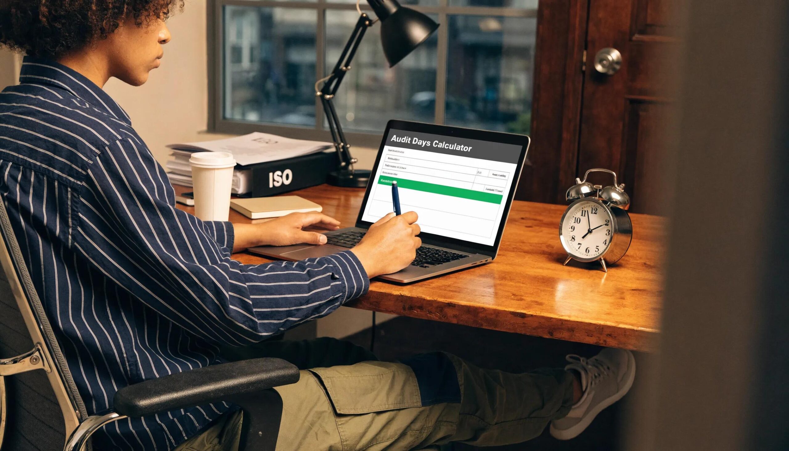 Person utilizing an audit days calculator while preparing for ISO certification audits